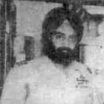 Vintage grainy photograph of a bearded, turbaned Air Force officer standing indoors