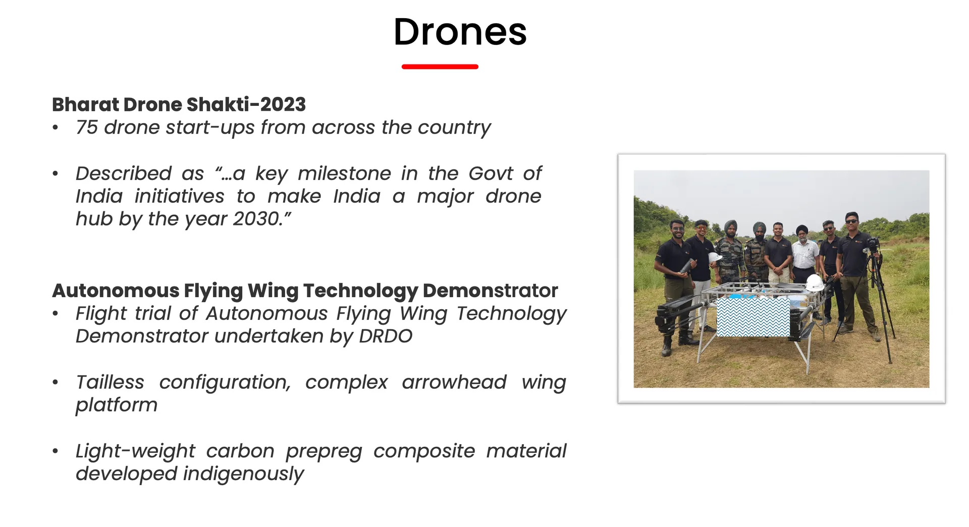Presentation slide titled Drones covering Bharat Drone Shakti-2023 and DRDO's Autonomous Flying Wing Technology Demonstrator, with a photo of the team beside the tailless flying-wing drone